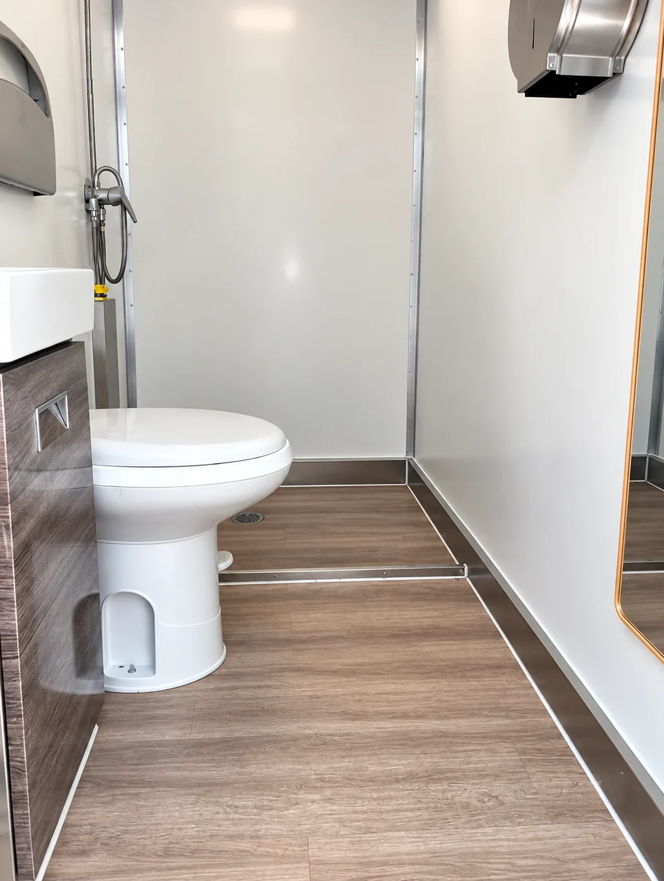 Toilet and shower enclosure in a shower and restroom combination trailer rental